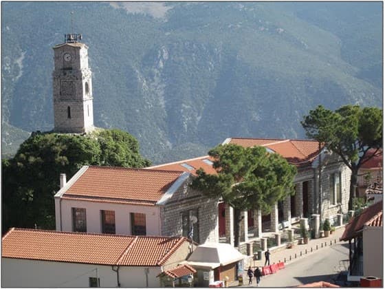 Εκκλησία και χωριό Αράχωβα με βουνά στο φόντο